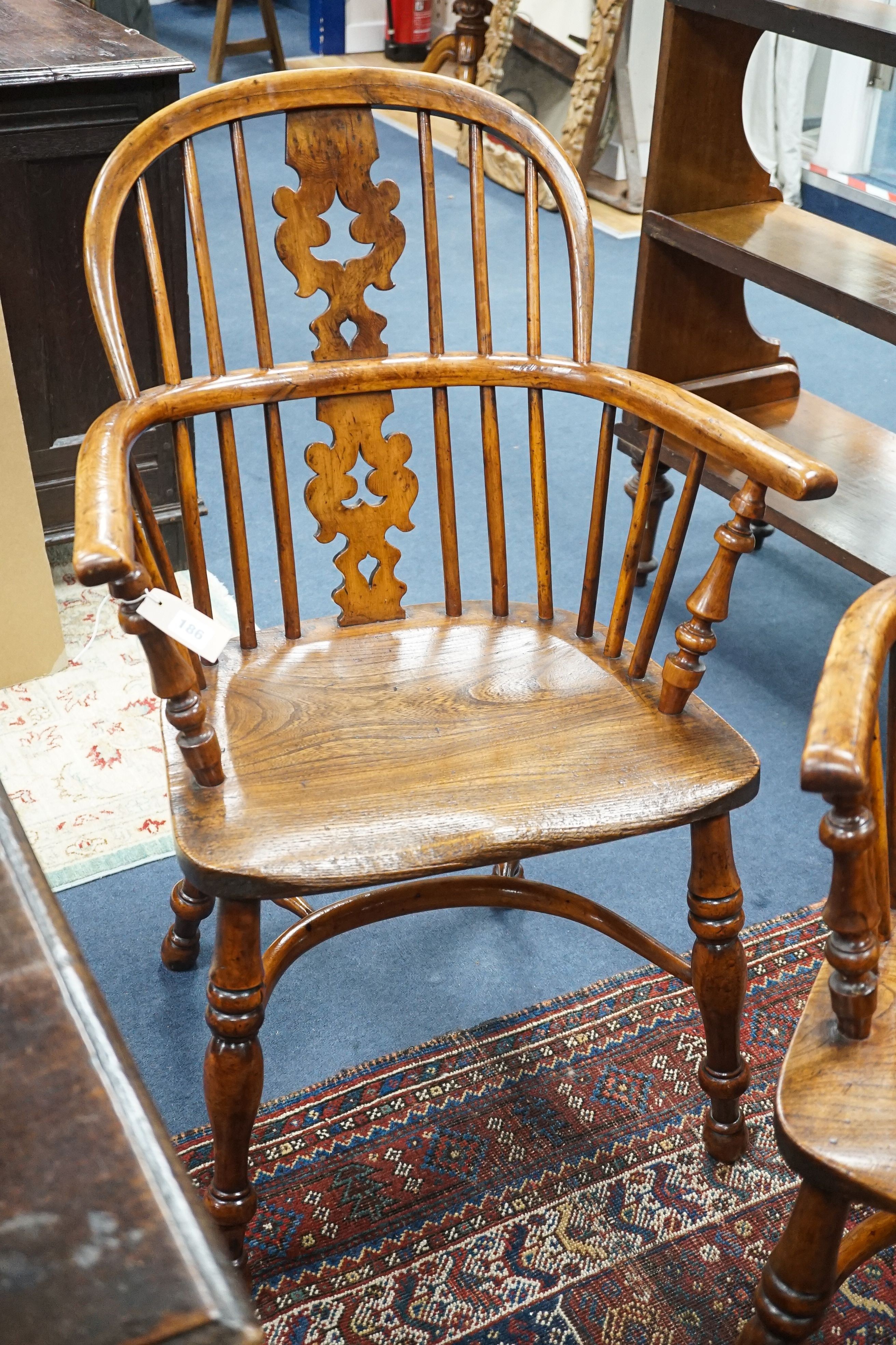 A pair of 19th century Yorkshire area yew and elm Windsor elbow chairs with crinoline stretchers, width 61cm, depth 40cm, height 95cm